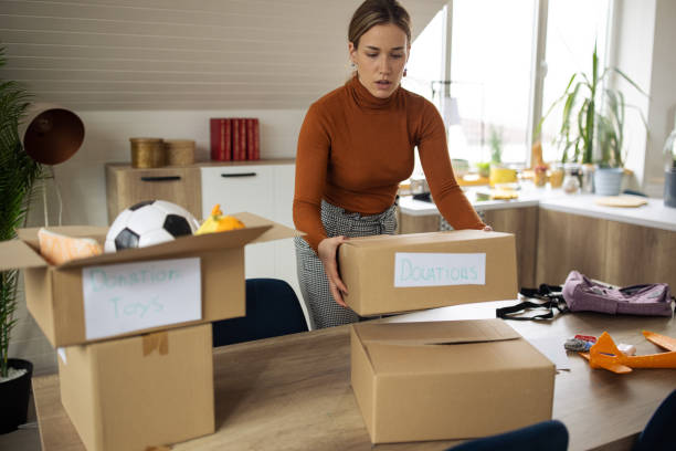istock Female volunteer, carrying the cardboard boxes for donation 1387287913