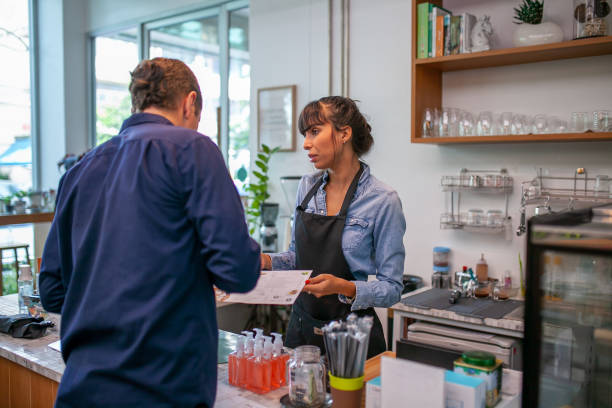 istock happy barista take order from customer. 1387288066