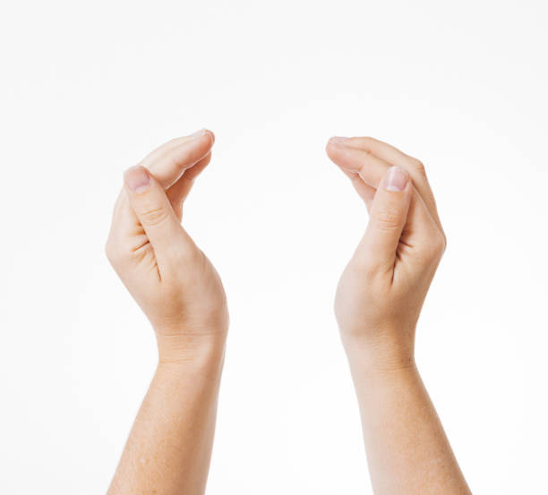 istock Woman curves her hands in a caring gesture around space for your object or copy 1387289025