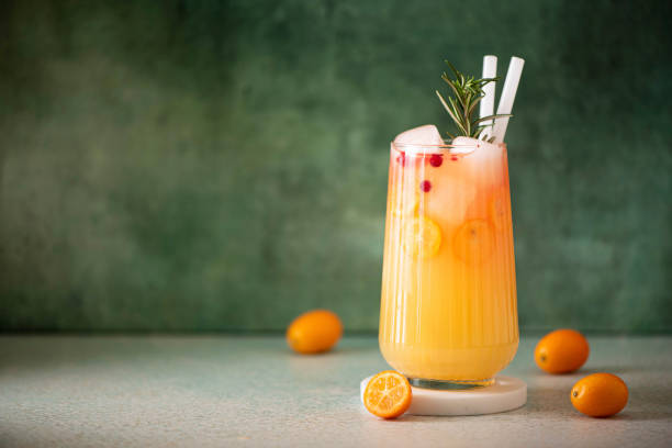 freshly squeezed orange juice with kumquat slices in a glass