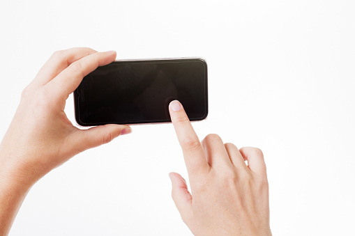 Woman manipulates her cellphone.