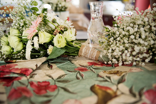 Flowers on table ready for a wedding DIY bouquet. No people. Horizontal indoors shot.