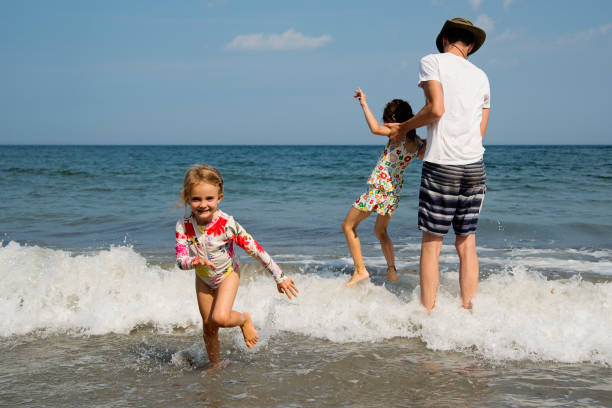 Cute little boy in swimming tube having fun with his mother during summer day in the sea. Copy space.