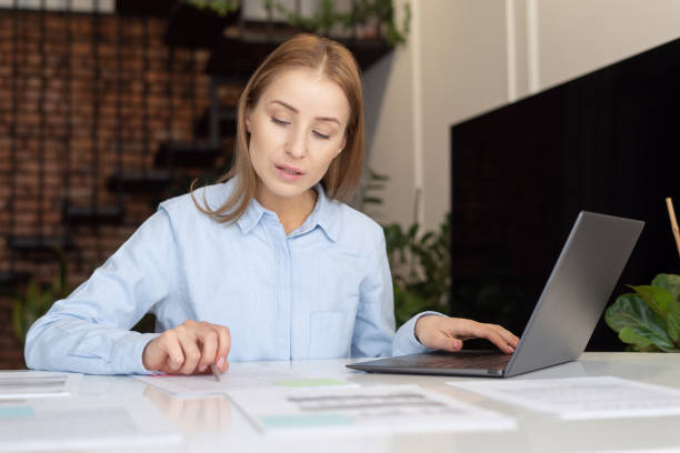 istock Confident and focused woman working from home 1387297453
