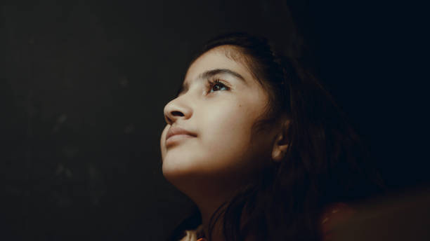 istock little girl doing homework in the dark 1387301832