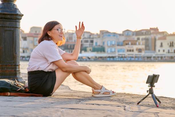 istock Woman recording stream on a smartphone on a tripod. 1387303129