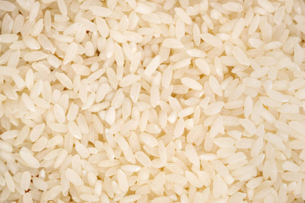 istock Long polished rice texture background. High quality photo 1387304171
