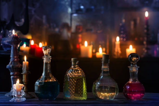 magic potions in bottles on wooden background stock photo