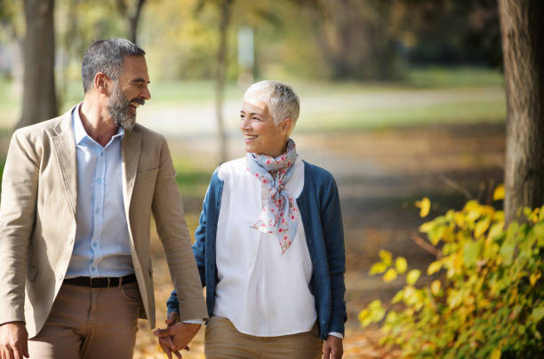 istock Mature couple walking through a forest. 1387306882