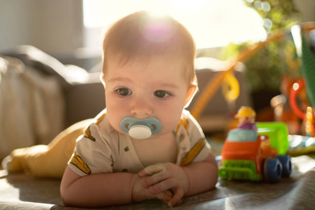 istock Cute Caucasian baby boy with pacifier in his mouth 1387307650
