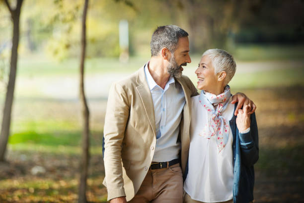 istock Mature couple walking through a forest. 1387307795