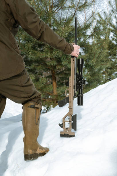 istock A sniper rifles from a rifle with an optical sight in man`s hands winter day 1387307928