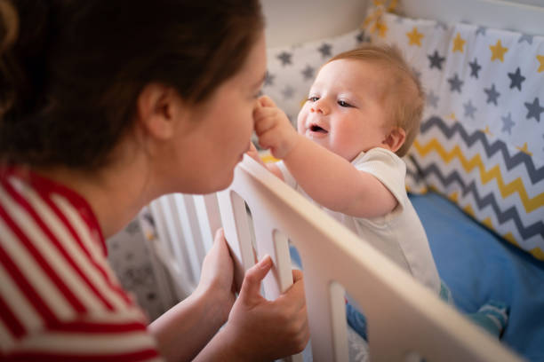 istock Curious baby boy touching his mother nose 1387308122