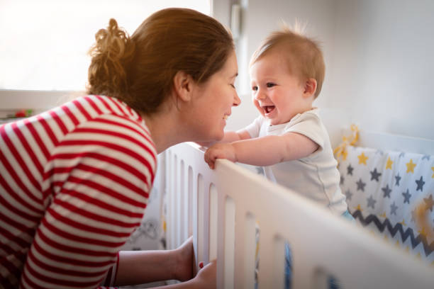 istock Mother leaning her head onto her baby son hands 1387308174