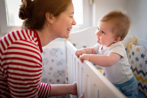 istock Curious baby boy looking at his mother, while she smiling 1387308177