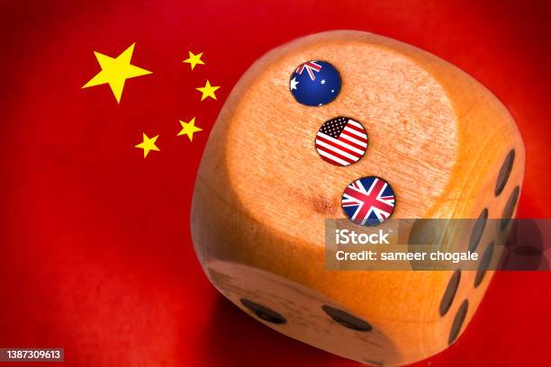 Australia Uk And Usa Aukus Alliance Countries Flags Paint Over On Wooden Dice Chinese Flag Paint On Background Stock Photo - Download Image Now