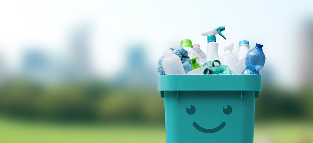 Cute smiling bin full of mixed plastic waste, recycling and separate waste collection concept