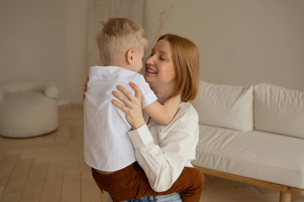 istock Mom and son with blond hair spend a good time hugging. 1387310107
