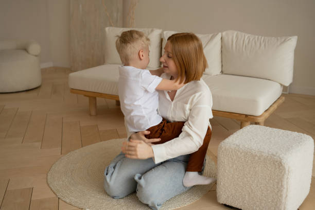 istock Mom and son with blond hair spend a good time hugging. 1387310253