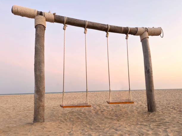 istock Swing hang in the evening atmosphere on the beach 1387312060
