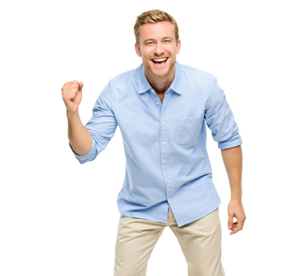 istock Shot of a handsome young man standing alone in the studio and cheering 1387312189