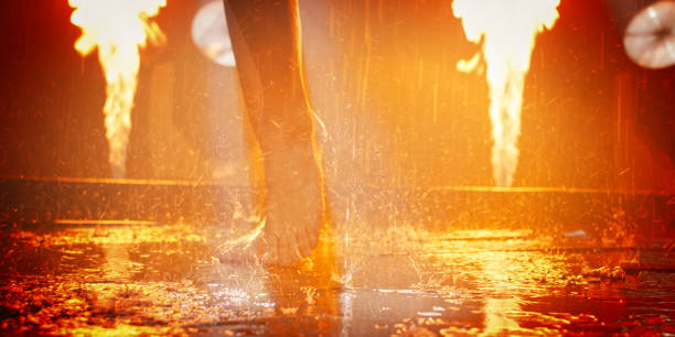 Abstract close-up picture of a person walking in the rain. Fire explosions in the background