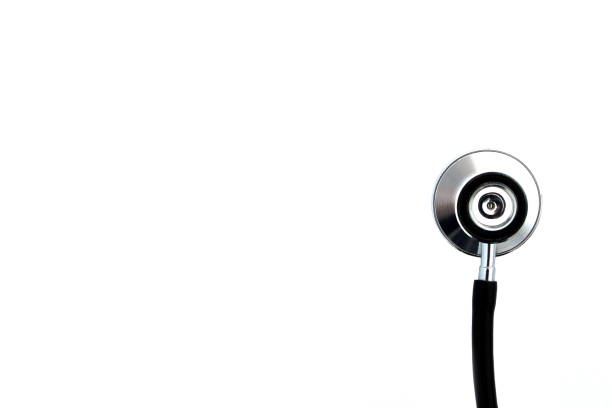 A metal stethoscope lies on a white isolated background.
