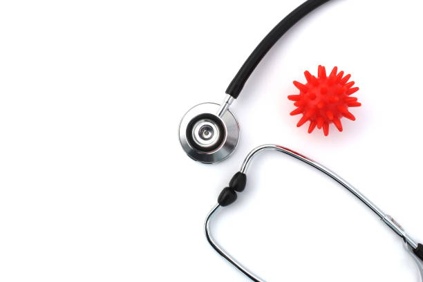 istock On a white background lies a stethoscope with a red virus mockup. 1387316290