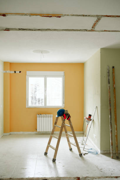 istock ladder, blue protective helmet and ear defenders at construction site. Home improvement, renovation 1387317844