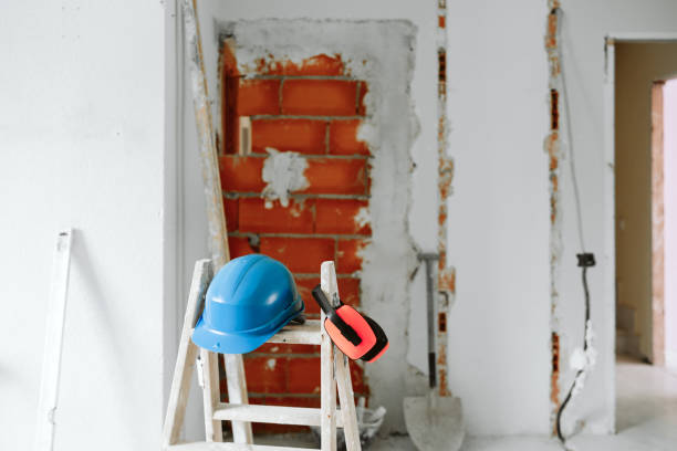 istock ladder, blue protective helmet and ear defenders at construction site. Home improvement. Bricks wall 1387317845