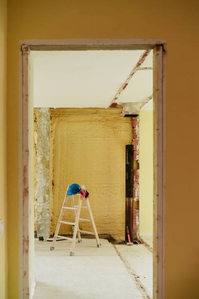 istock ladder, blue protective helmet and ear defenders at construction site. Home improvement, renovation 1387317851