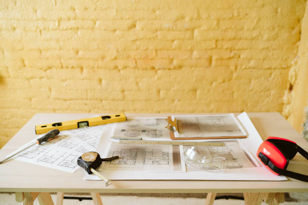 istock blueprints, ear defenders, protection glasses and tools on architect workspace at construction site 1387317856