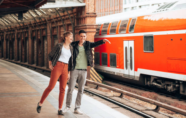 istock couple waiting the train 1387318301