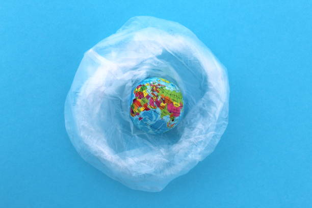 istock Model of the planet earth wrapped in a plastic bag. 1387319452
