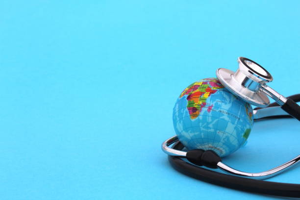 istock The globe is lying with a stethoscope on a blue background. 1387319561