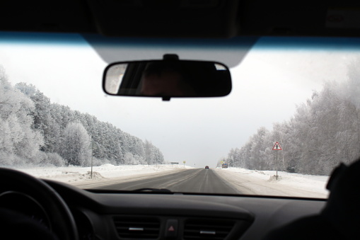 View from the interior of the car on the winter highway.