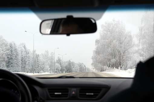 View from the interior of the car on the winter highway.