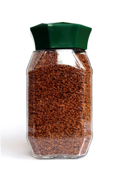 istock A glass jar with fragrant instant coffee stands on a white background. 1387320658