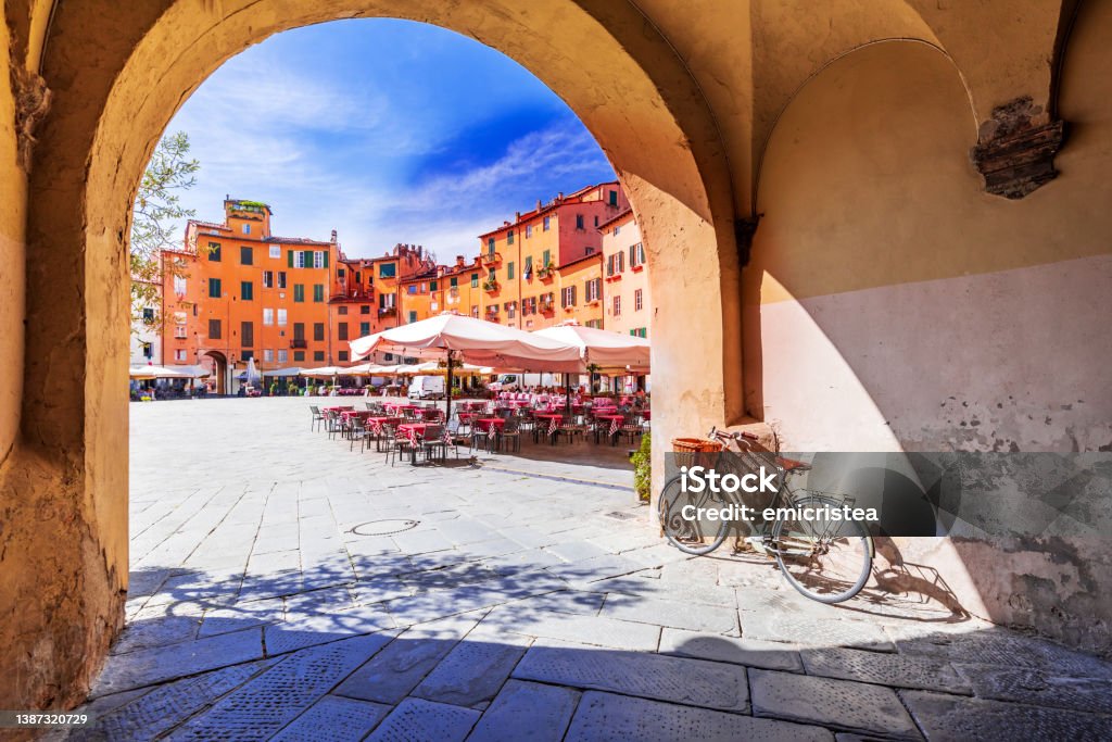 Lucca, Italy - Piazza dell'Anfiteatro, scenic sight of Tuscany Lucca, Italy - View of Piazza dell'Anfiteatro square through the arch, ancient Roman Empire amphitheater, famous Tuscany. Lucca Stock Photo