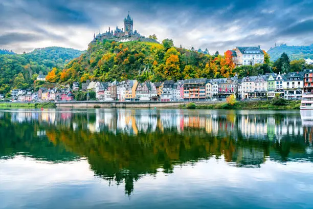 Cochem, Germany. Colored sunset with romantic Moselle River valley, Rhineland-Palatinate in red autumn colors.
