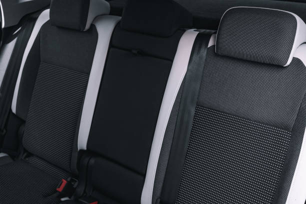 istock Interior of new car is viewed from inside. Passenger seats in back. Sofa and empty space 1387321150