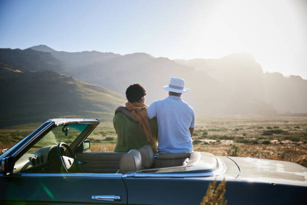 istock Affectionate couple enjoying the scenic view during a road trip 1387322137