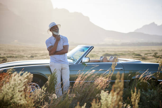 istock Smiling mature man enjoying the scenic view during a break from a drive 1387322216