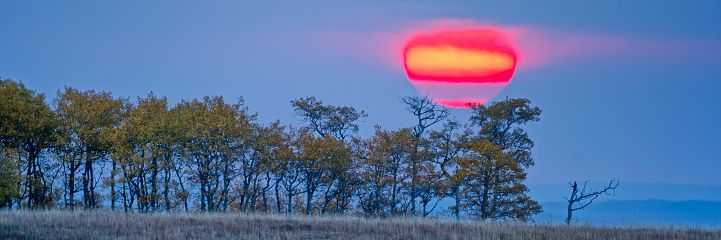 Dramatic sunrise over pasture land in the foothills of rural Alberta Canada