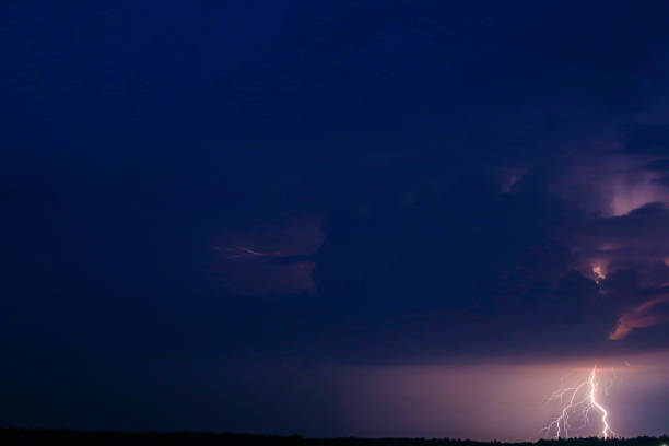 istock Late evening with dark cloudy sky with scatter lightning 1387324724