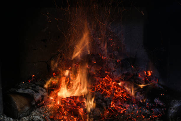 Bright burning wood in a fireplace with sparks close-up