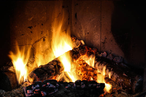 istock Bright burning wood in a fireplace with sparks close-up 1387324803