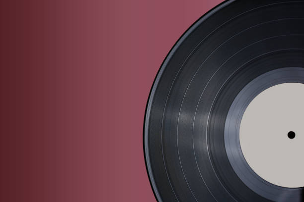 istock Classic vinyl record close-up on a red burgundy background, outdated data storage, music 1387324952