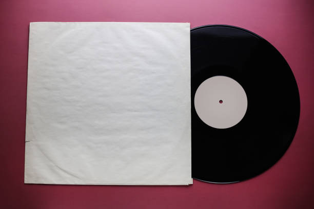 istock Classic vinyl record with packaging closeup on a red burgundy background, outdated data storage, music 1387325054