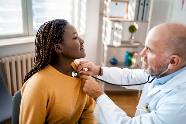 istock Experienced doctor examining black female patient with stethoscope 1387325061